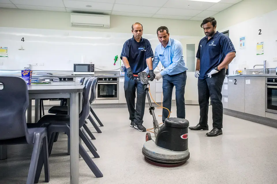 The Clean Crew team members learning practical floor-care equipment